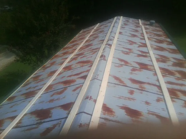 Rusted metal roof panels with new wood purlins before replacement — Storm Damage Roof Repair in Dennis Port by Roofing Brothers